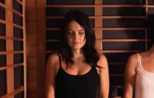 Women in sauna with eyes closed at P3 Recovery to improve sleep quality